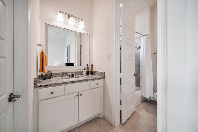 bathroom with tile patterned flooring, vanity, toilet, shower / bath combination with curtain, and baseboards