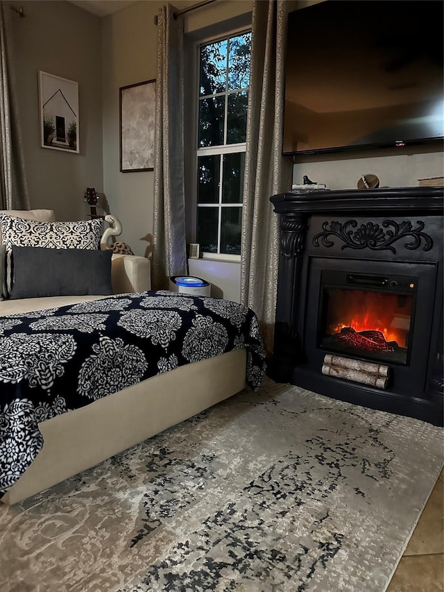 bedroom with a glass covered fireplace