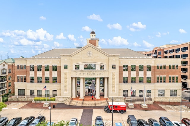 view of building exterior with uncovered parking