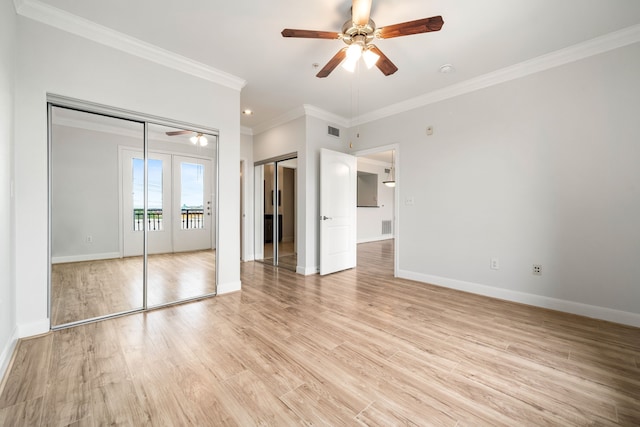 unfurnished bedroom featuring crown molding, baseboards, visible vents, and light wood-type flooring