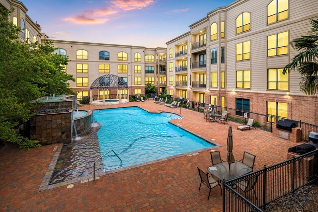 pool with a patio, a gazebo, and a community hot tub