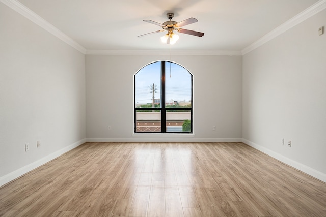 spare room with ceiling fan, ornamental molding, and light wood-type flooring