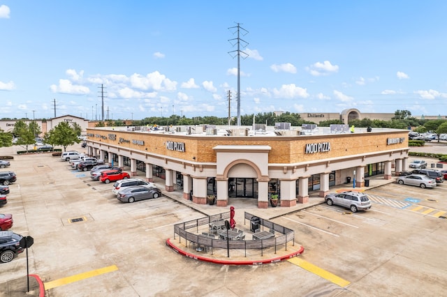 view of building exterior featuring uncovered parking