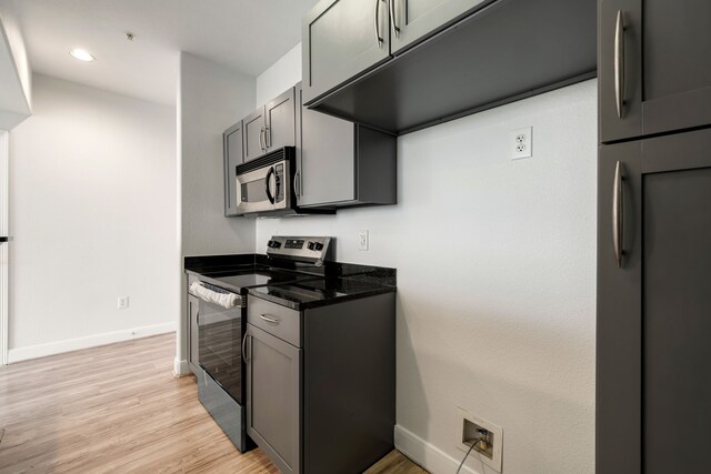 kitchen featuring recessed lighting, baseboards, appliances with stainless steel finishes, and light wood-type flooring