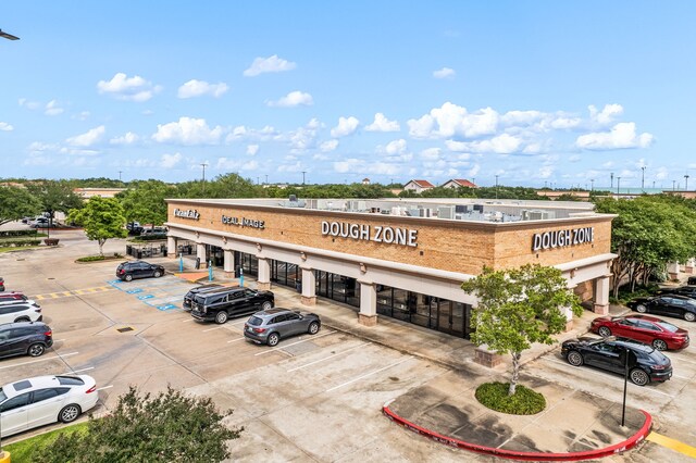 view of property featuring uncovered parking