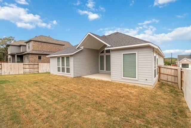 back of property with a lawn, a fenced backyard, and a patio area