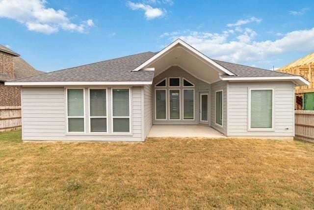 back of house with a yard, a patio, and fence