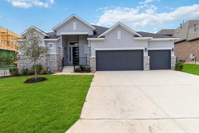 view of front of property featuring a garage, a front lawn, stucco siding, and driveway