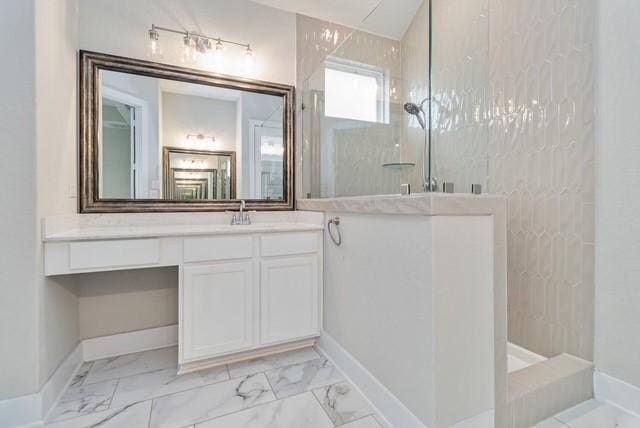 bathroom featuring baseboards, walk in shower, marble finish floor, and vanity
