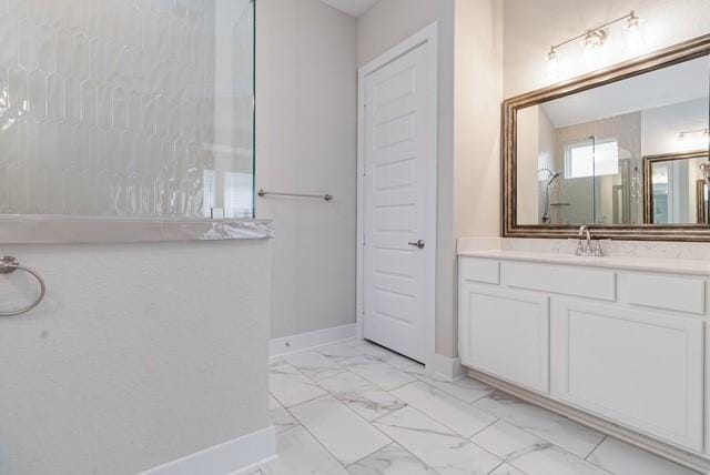 full bathroom featuring a walk in shower, baseboards, marble finish floor, and vanity