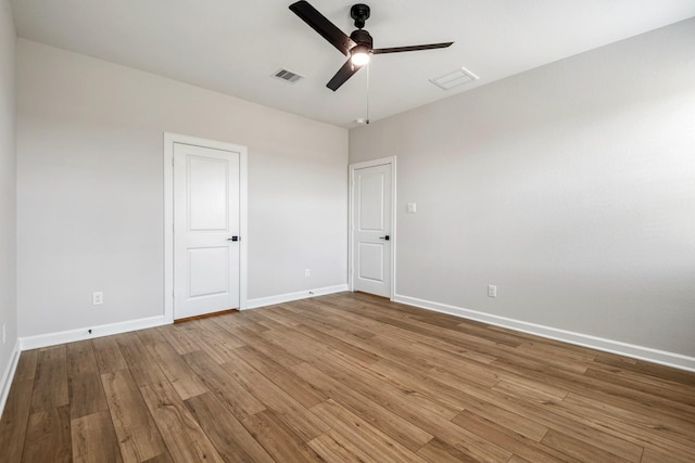 15686 Honey Cove Dr, Conroe, TX 77303 - unfurnished room featuring baseboards, ceiling fan, wood finished floors, and visible vents