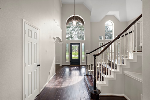 3615 Caleb Ln, Missouri City, TX 77459 - entrance foyer featuring a high ceiling, dark wood-type flooring, stairway, baseboards, and a chandelier