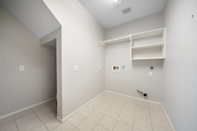 3615 Caleb Ln, Missouri City, TX 77459 - clothes washing area with hookup for an electric dryer, hookup for a gas dryer, hookup for a washing machine, light tile patterned floors, and baseboards
