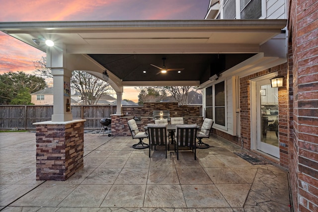 3615 Caleb Ln, Missouri City, TX 77459 - patio terrace at dusk with fence, outdoor dining area, grilling area, and a ceiling fan