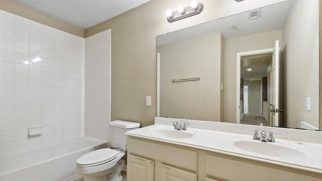 bathroom featuring double vanity, toilet, bathing tub / shower combination, and a sink