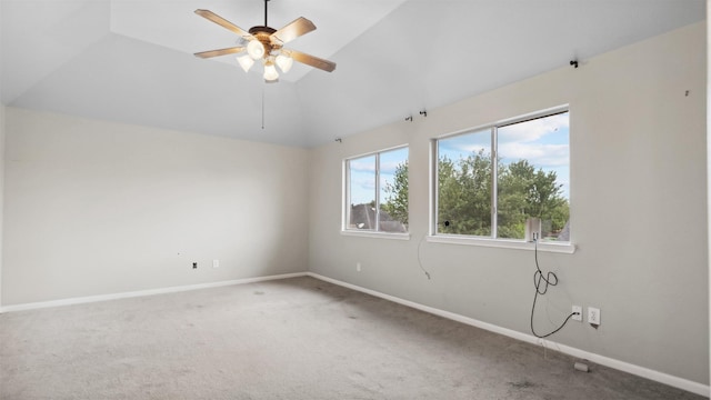 carpeted empty room with a ceiling fan, baseboards, and high vaulted ceiling