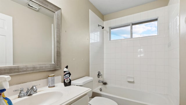 bathroom with vanity, shower / bathing tub combination, toilet, and visible vents