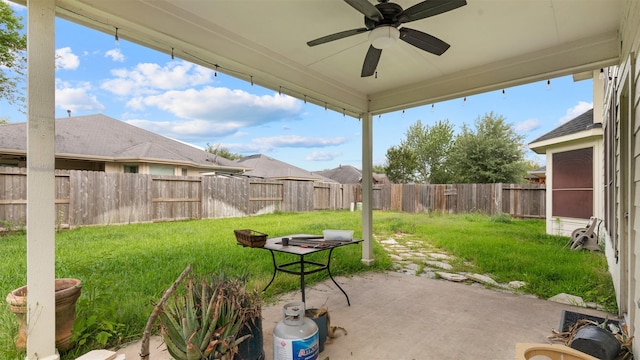 view of patio with a fenced backyard and a ceiling fan