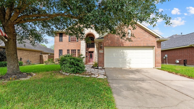 traditional-style house with brick siding, driveway, a front lawn, and a garage