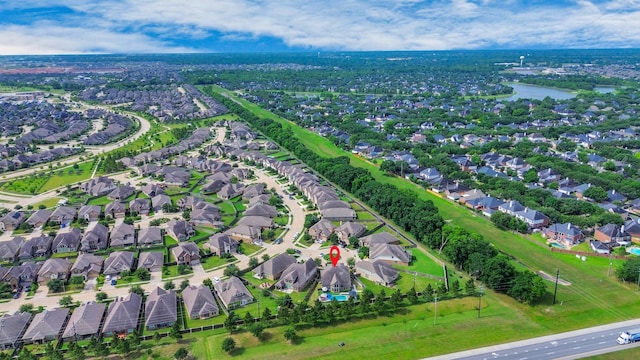 aerial overview of property's location with nearby suburban area and a nearby body of water