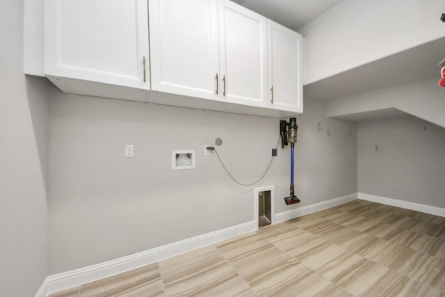 laundry area featuring cabinet space, hookup for a gas dryer, hookup for a washing machine, and baseboards