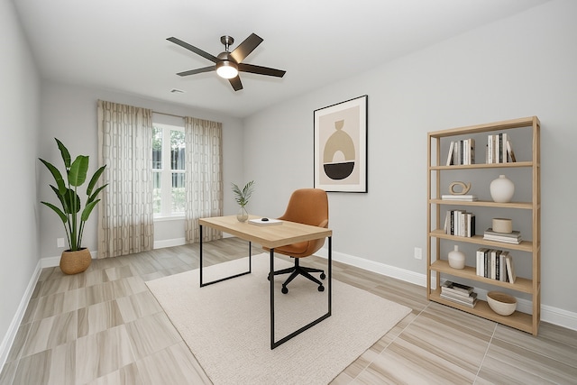 office area featuring baseboards and a ceiling fan
