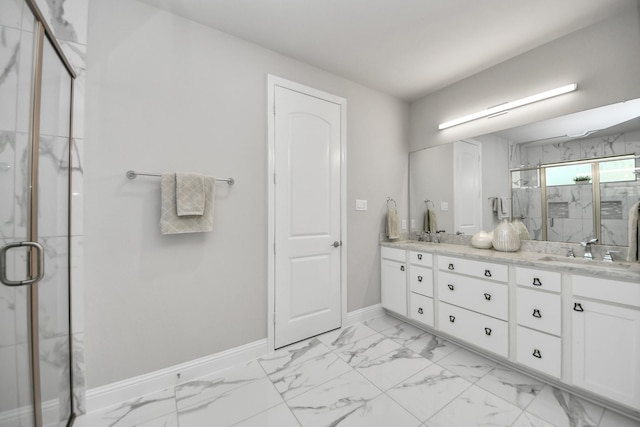 full bath with a marble finish shower, baseboards, double vanity, and marble finish floors