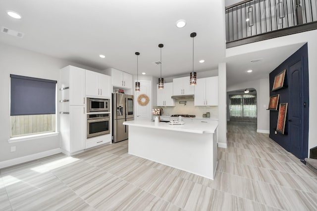 kitchen featuring stainless steel appliances, light countertops, baseboards, white cabinets, and recessed lighting