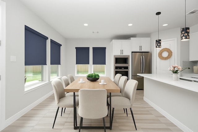 dining space featuring baseboards, recessed lighting, and light wood-type flooring