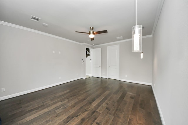 unfurnished room with dark wood finished floors, baseboards, crown molding, and a ceiling fan