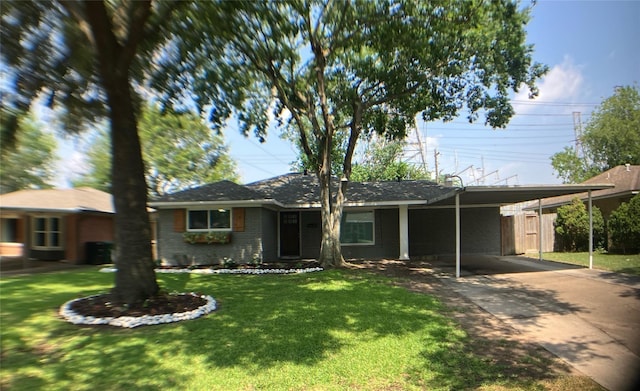ranch-style house featuring concrete driveway, brick siding, a front lawn, and a carport