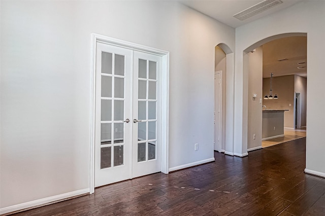 9154 Sunlight Oak Ln, Houston, TX 77070 - unfurnished room featuring arched walkways, french doors, baseboards, visible vents, and hardwood / wood-style flooring