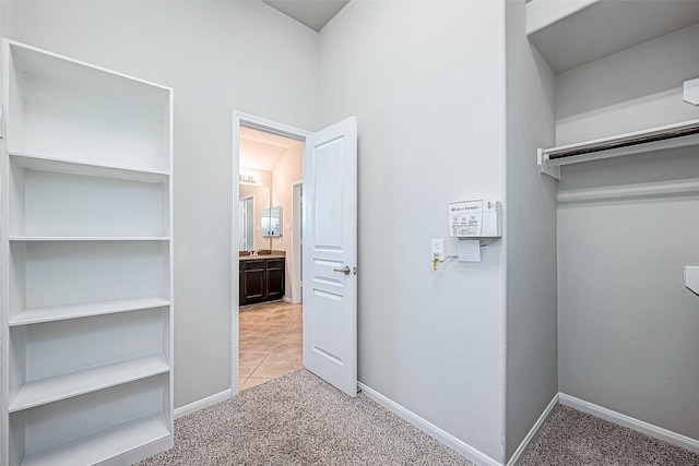 9154 Sunlight Oak Ln, Houston, TX 77070 - walk in closet featuring light colored carpet