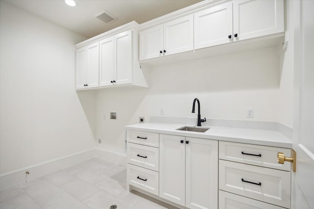 1016 Alexander St, Houston, TX 77008 - clothes washing area featuring hookup for an electric dryer, hookup for a washing machine, cabinet space, light tile patterned floors, and recessed lighting
