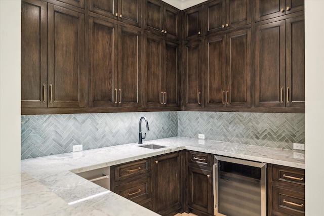 1016 Alexander St, Houston, TX 77008 - kitchen featuring beverage cooler, a sink, tasteful backsplash, light stone counters, and dark brown cabinets
