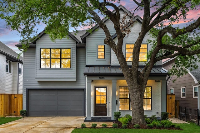 1016 Alexander St, Houston, TX 77008 - view of front of house featuring a standing seam roof, fence, an attached garage, driveway, and metal roof