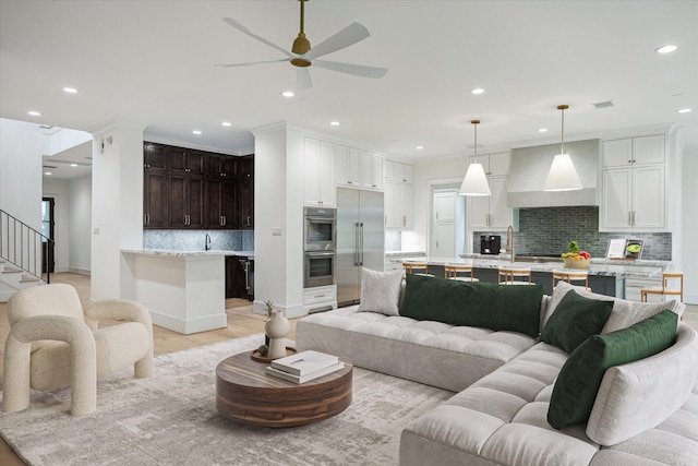 1016 Alexander St, Houston, TX 77008 - living area featuring ceiling fan, recessed lighting, light wood-style flooring, stairs, and baseboards