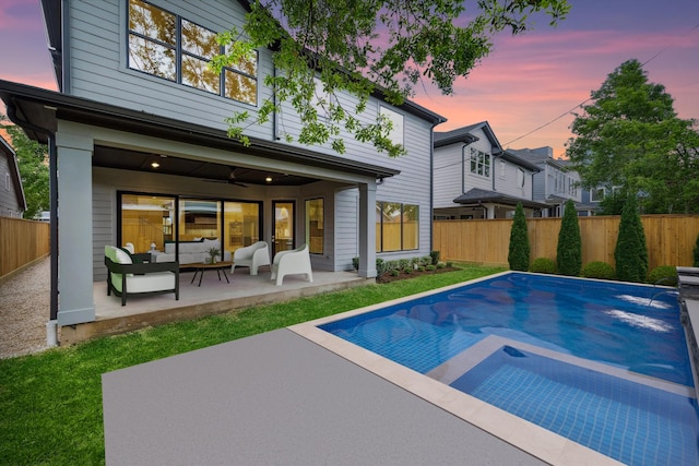1016 Alexander St, Houston, TX 77008 - back of property at dusk featuring outdoor lounge area, a fenced backyard, and a patio