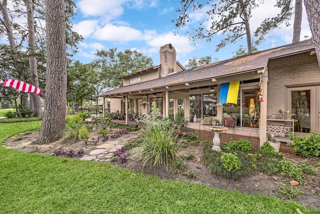 6303 Pebble Beach Dr, Houston, TX 77069 - rear view of house with a shingled roof, a chimney, a yard, and a patio area