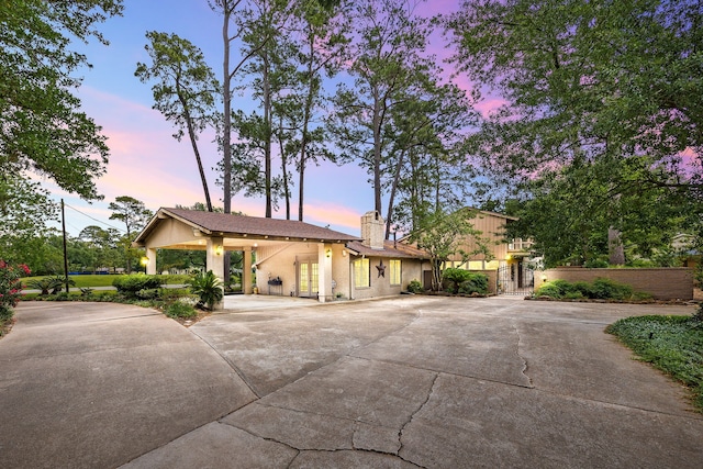 6303 Pebble Beach Dr, Houston, TX 77069 - view of front of property featuring curved driveway, a chimney, and stucco siding
