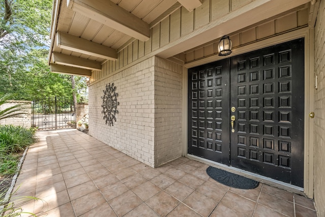 6303 Pebble Beach Dr, Houston, TX 77069 - property entrance featuring brick siding, a gate, and board and batten siding