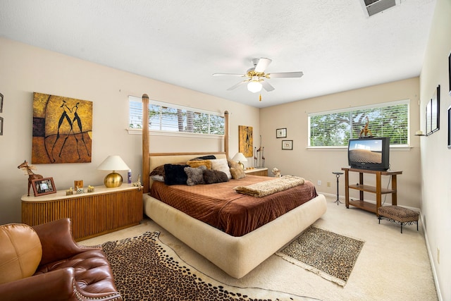 6303 Pebble Beach Dr, Houston, TX 77069 - bedroom featuring visible vents, a ceiling fan, light carpet, and multiple windows