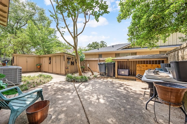 6303 Pebble Beach Dr, Houston, TX 77069 - view of patio / terrace featuring fence, an outdoor structure, cooling unit, and a storage shed