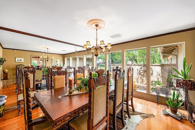 6303 Pebble Beach Dr, Houston, TX 77069 - dining area featuring an inviting chandelier, ornamental molding, light wood-style flooring, and visible vents