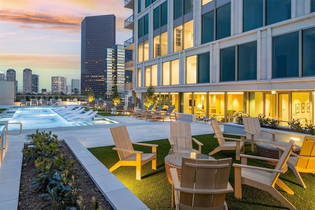 exterior space featuring a city view, a swimming pool, and a patio area