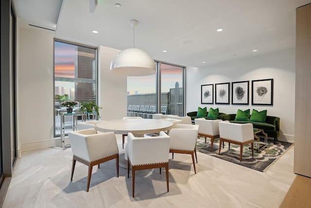 dining area featuring a view of city, recessed lighting, and expansive windows