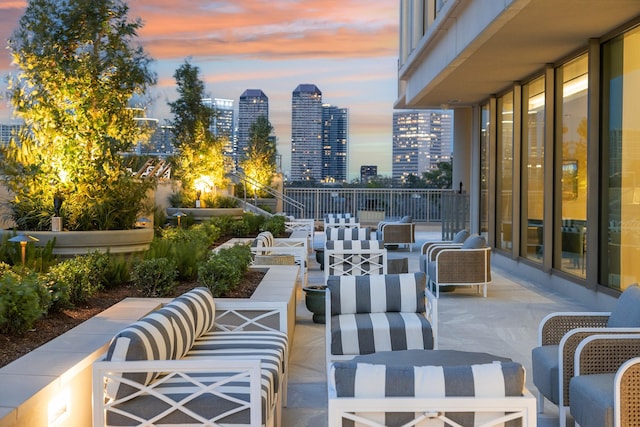 patio terrace at dusk with a view of city and outdoor lounge area
