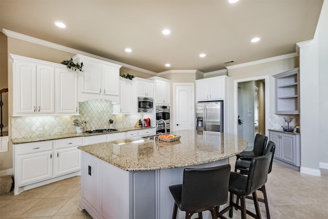 2402 Chesley Park Ct, Katy, TX 77494 - kitchen featuring appliances with stainless steel finishes, a breakfast bar, decorative backsplash, light tile patterned floors, and white cabinets