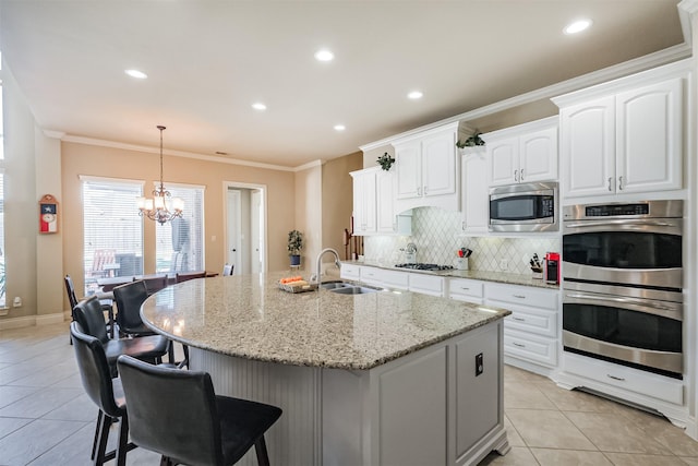 2402 Chesley Park Ct, Katy, TX 77494 - kitchen with stainless steel appliances, a sink, a chandelier, backsplash, and light tile patterned floors