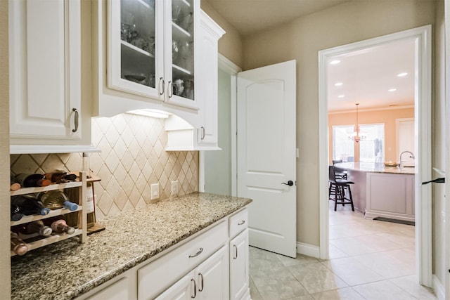 2402 Chesley Park Ct, Katy, TX 77494 - bar featuring tasteful backsplash and light tile patterned flooring